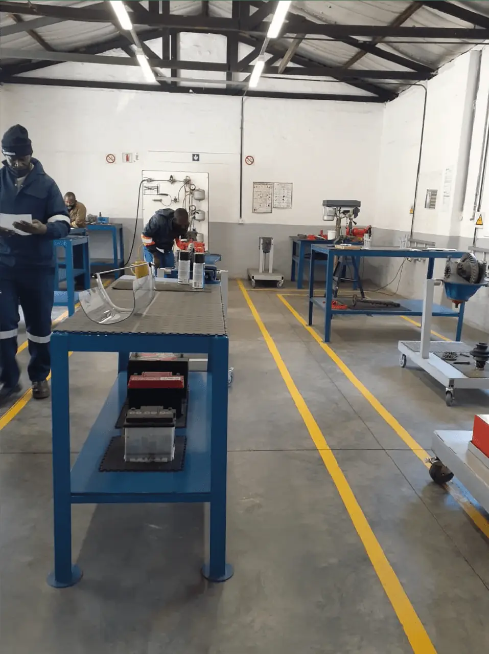 Trainees and instructor working together on the workshop floor